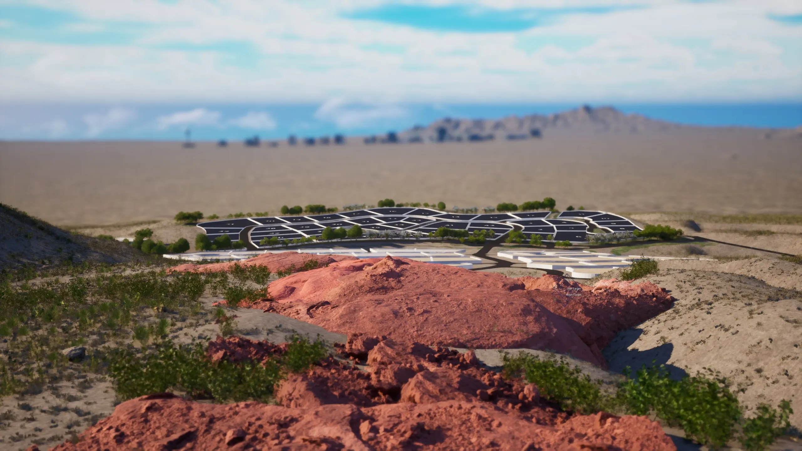 Red rock in the foreground, the lots on the desert floor beyond
